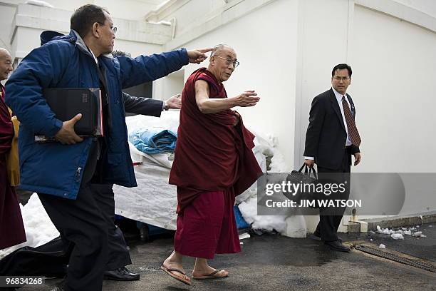 Exiled Tibetan spiritual leader the Dalai Lama walks out the doors of the Palm Room of the White House in Washington, DC, Febraury 18, 2010 after...