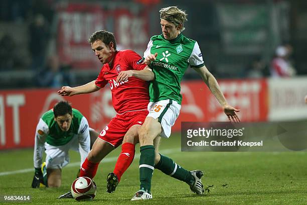 Peter Niemeyer of Bremen tackles Wout Brama of Enschede during the UEFA Europa League knock-out round, first leg match between FC Twente Enschede and...