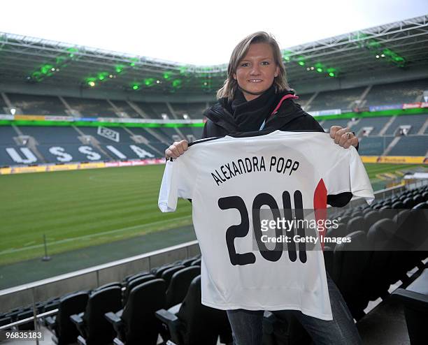 Alexandra Popp presents a jersey prior the FIFA Women's World Cup 2011 Countdown event at the Borussia Park Arena on February 18, 2010 in...