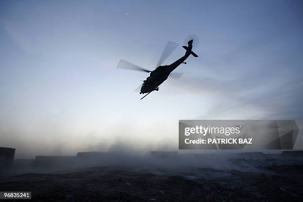 Army Blackhawk helicopter flies over Trikh Nawar, a poppy farmland area on the northeastern outskirts of Marjah, on February 18, 2010. About 15,000...