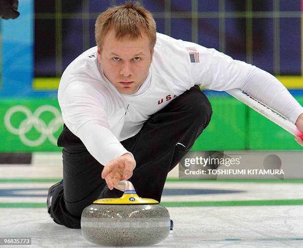 Second Jeff Isaacson throws the stone during their round robin match against Denmark in the Vancouver Winter Olympic men's curling games at the...