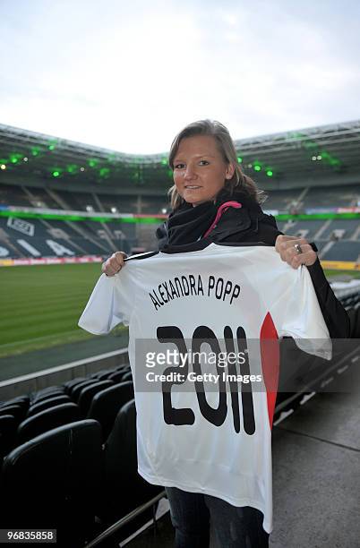 Alexandra Popp presents a jersey prior the FIFA Women's World Cup 2011 Countdown event at the Borussia Park Arena on February 18, 2010 in...
