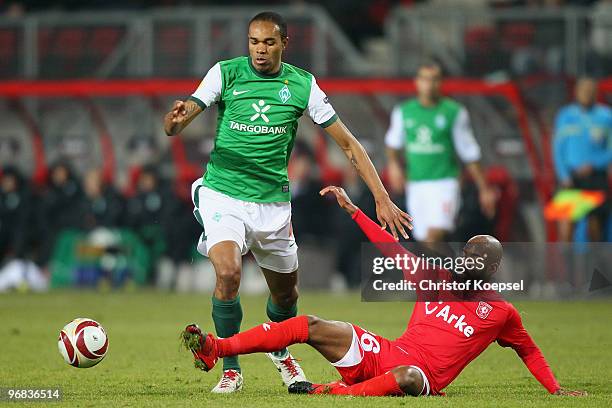 Dwight Tiendalli of Enschede fouls Naldo of Bremen during the UEFA Europa League knock-out round, first leg match between FC Twente Enschede and SV...