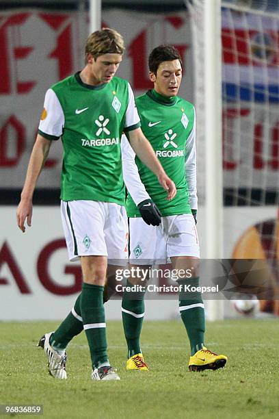 Peter Niemeyer of Bremen and Mesut Oezil of Bremen look dejected after the first goal of Enschede during the UEFA Europa League knock-out round,...