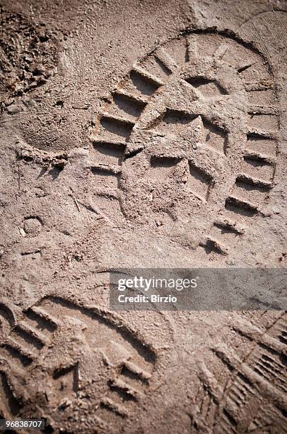 a boot print in the mud close-up - mud footprint stock pictures, royalty-free photos & images