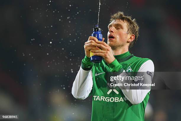 Per Mertesacker of Bremen looks dejected after losing 0-1 the UEFA Europa League knock-out round, first leg match between FC Twente Enschede and SV...