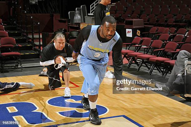 Strength and conditioning coach Steve Hess works with Ty Lawson of the Denver Nuggets during practice prior to the game against the Cleveland...