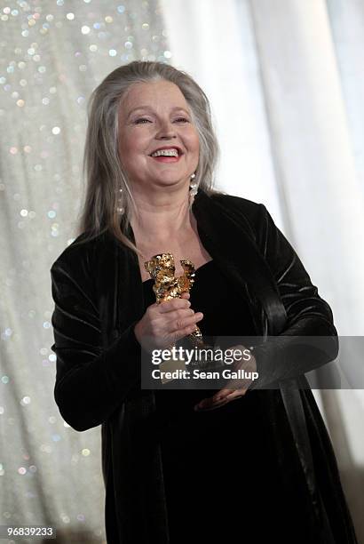 Actress Hanna Schygulla holds up her Honorary Golden Bear for lifetime achievement she received at the 60th Berlinale International Film Festival at...