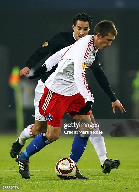 Robert Tesche of Hamburg and Otman Bakkal of Eindhoven compete for the ball during the UEFA Europa League knock-out round, first leg match between...