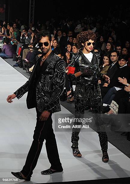 Models present creations by Pakistani designer Ammar Belal on the third day of Pakistan Fashion Design Council Fashion Week in Lahore on February 18,...
