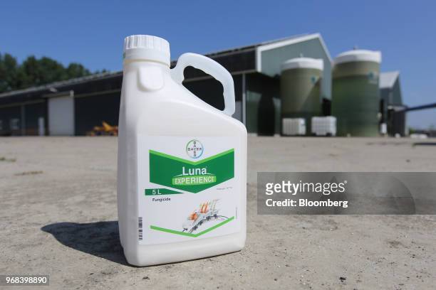 Bottle of Luna fungicide, produced by Bayer CropScience AG, stands beside farm buildings in this arranged photograph in Abbenes, Netherlands, on...