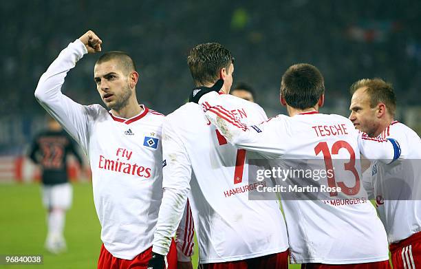 Mladen Petric of Hamburg celebrates with his team mates the first goal during the UEFA Europa League knock-out round, first leg match between...