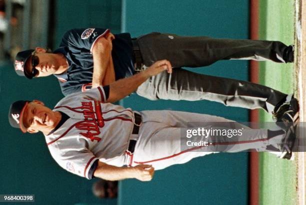 Atlanta Braves Manager Bobby Cox looks to home plate umpire Ed Montague for help after an argument with third base umpire Tom Hallion turns out to be...