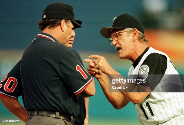 Florida Marlins' manager Jim Leyland argues with umpires Tom Hallion and Ed Montague during 4th inning action against the Atlanta Braves 01 August...