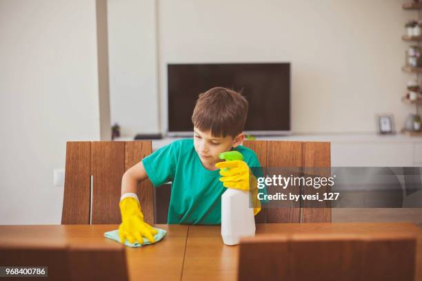 boy polishing wooden table with cloth - kids with cleaning rubber gloves 個照片及圖片檔