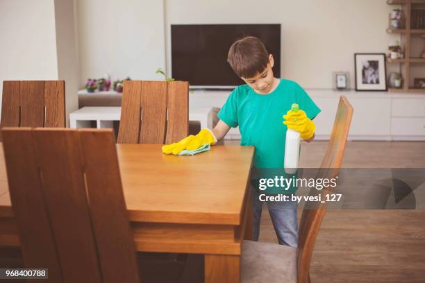 boy polishing wooden table with cloth - kids with cleaning rubber gloves 個照片及圖片檔