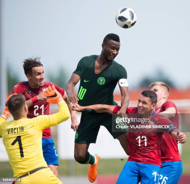 Czech Republic's Tomas Vaclik, Josef Sural and Marek Suchy vie for the ball with Nigeria's midfielder John Obi Mikel during the international...