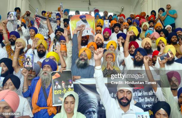 Sikh hardliners raising pro-khalistan slogans and displaying posters of Jarnail Singh Bhindranwale and other militants in front of Akal Takht during...