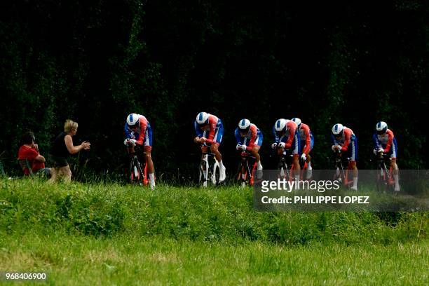 Spectator cheers as riders of France's Groupama - FDJ cycling team compete during the third stage of the 70th edition of the Criterium du Dauphine...