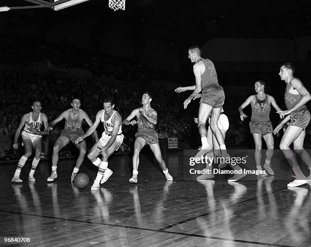 Guard Frankie Brian of the Fort Wayne Zollner Pistons reaches for the ball while being guarded by Bobby Wanzer of the Rochester Royals during a game...