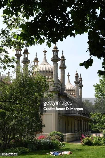 Two women sunbathe on the grass outside the Royal Pavilion on June 6, 2018 in Brighton, England. Temperatures in Brighton reached 21 degrees celcius,...