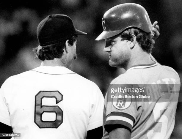 Kansas City Royals player George Brett looks behind Boston Globe first baseman Bill Buckner during a game at Fenway Park on Aug. 12, 1985.