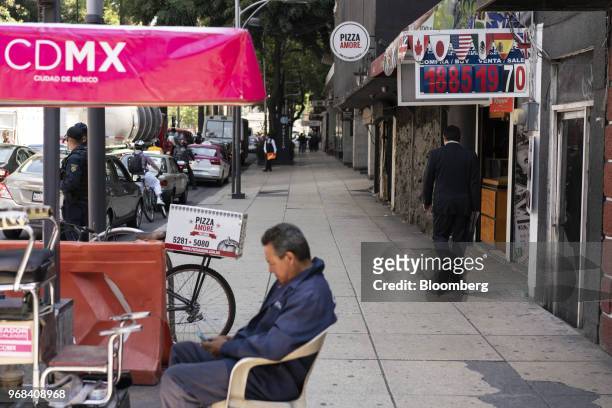 Shoe shine stand sits outside a currency exchange location in Mexico City, Mexico, on Tuesday, June 5, 2018. The Mexican peso sank to its weakest in...