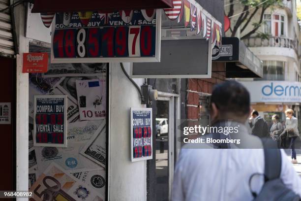 Pedestrian passes in front of a currency exchange location in Mexico City, Mexico, on Tuesday, June 5, 2018. The Mexican peso sank to its weakest in...