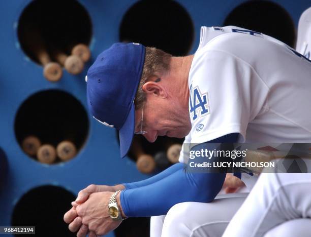 Los Angeles Dodgers' manager Jim Tracy sits dejected in the dugout in the ninth inning during the game against the San Diego Padres, in Los Angeles,...