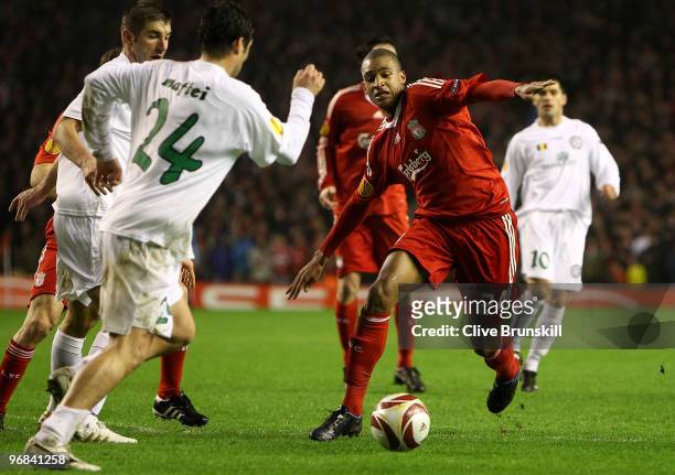 David Ngog of Liverpool in action with Vasile Maftei of Unirea Urziceni during the UEFA Europa League Round 32 first leg match between Liverpool and...