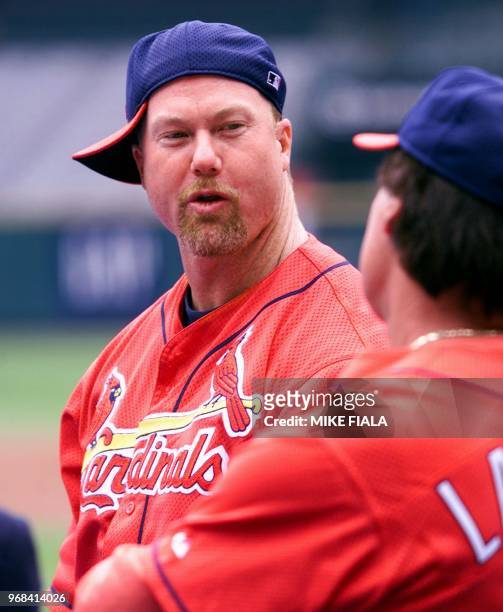 St. Louis Cardinals slugger Mark McGwire speaks with manager Tony La Russa during an afternoon workout at Busch Stadium, 04 October 2000, in St....