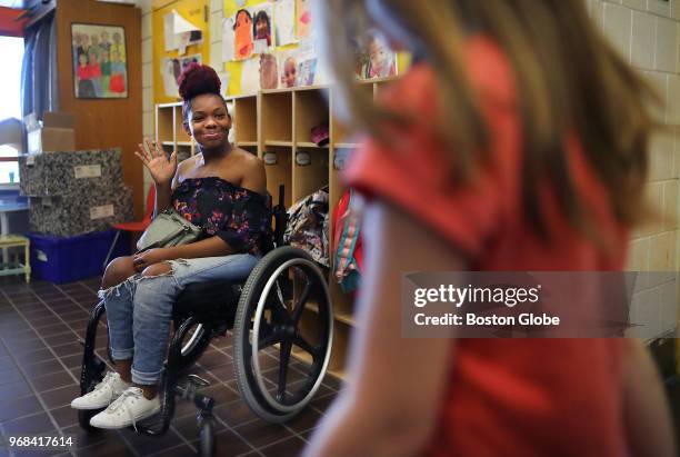 Kai Leigh Harriott waves to a student at the Josiah Quincy School in Boston on May 24, 2018. Harriott was paralyzed when she was shot by a stray...