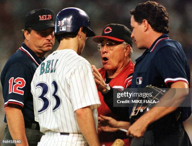 Umpires Gerry Davis and Paul Emmel watch closely as Arizona Diamondbacks Jay Bell confronts Cincinnati Reds manager Jack McKeon after Reds pitcher...