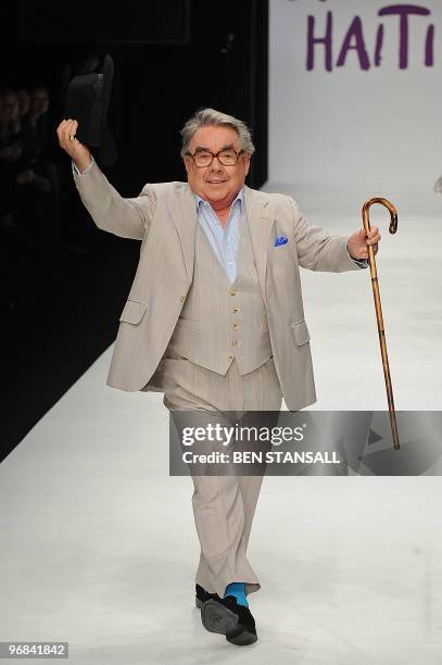 British comedian Ronnie Corbett walks down the catwalk during Naomi Campbell's 'Fashion for Relief Haiti' fashion show at Somerset House on February...