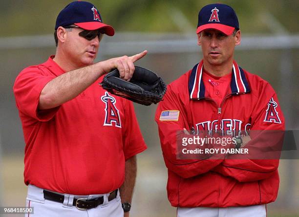 Anaheim Angels manager Mike Scioscia talks with pitching coach Bud Black as the Angels open spring training drills, 15 February in Tempe, Arizona....