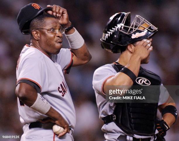 San Francisco Giants' manager Dusty Baker and catcher Bobby Estalella wait on the mound after Baker relieved pitcher Chad Zerbe for Tim Worrell...