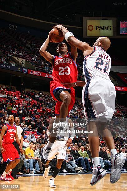 Jarvis Hayes of the New Jersey Nets blocks a shot by Louis Williams of the Philadelphia 76ers during the game at the IZOD Center on January 31, 2010...