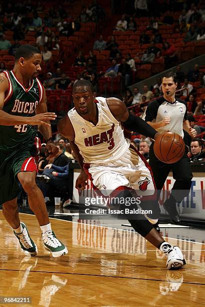Dwyane Wade of the Miami Heat drives the ball up court against Charlie Bell of the Milwaukee Bucks during the game at American Airlines Arena on...
