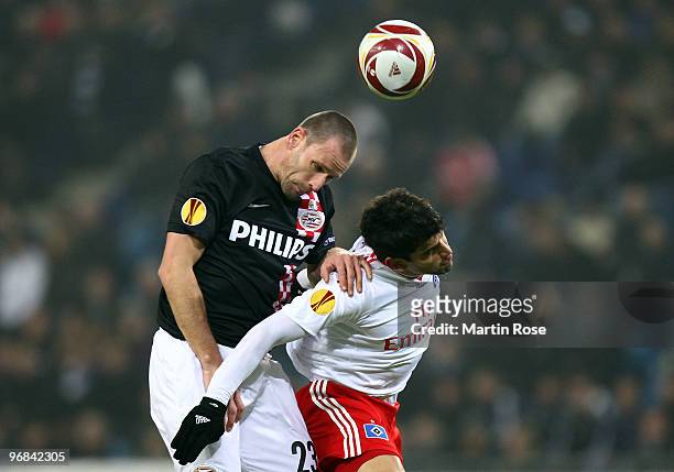 Tomas Rincon of Hamburg and Andre Ooijer of Eindhoven head for the ball during the UEFA Europa League knock-out round, first leg match between...
