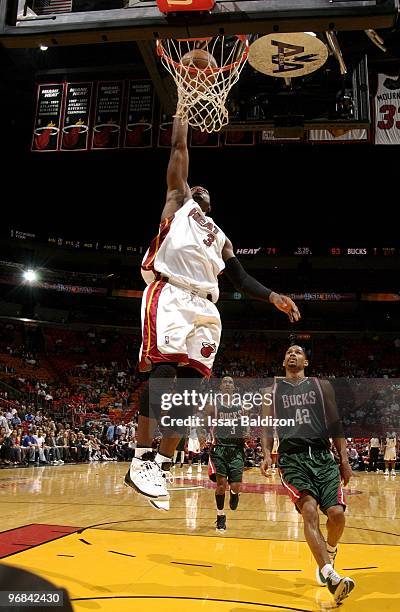 Dwyane Wade of the Miami Heat shoots a layup against Charlie Bell of the Milwaukee Bucks during the game at American Airlines Arena on February 1,...
