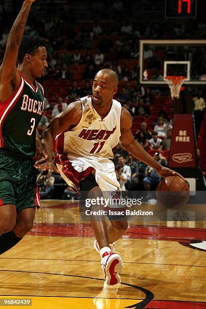 Rafer Alston of the Miami Heat drives the ball up court against Brandon Jennings of the Milwaukee Bucks during the game at American Airlines Arena on...