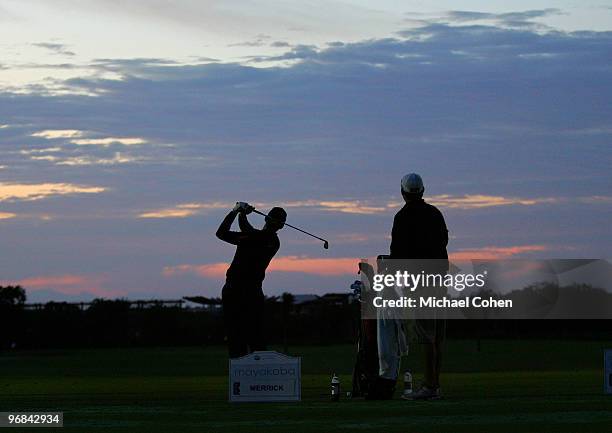 John Merrick practices on the driving range at dawn during the first round of the Mayakoba Golf Classic at El Camaleon Golf Club held on February 18,...