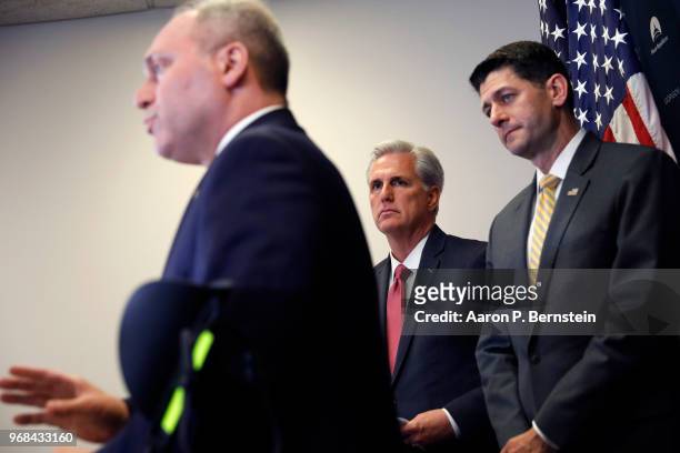 House Speaker Paul Ryan and House Majority Leader Rep. Kevin McCarthy look on as Majority Whip Rep. Steve Scalise speaks with reporters during a news...