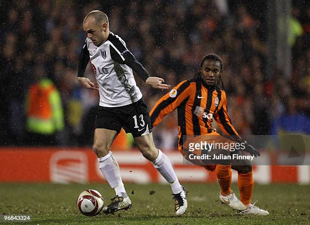 Danny Murphy of Fulham moves away from Willian of Donetsk during the UEFA Europa League 1st leg match between Fulham and Shakhtar Donetsk at Craven...