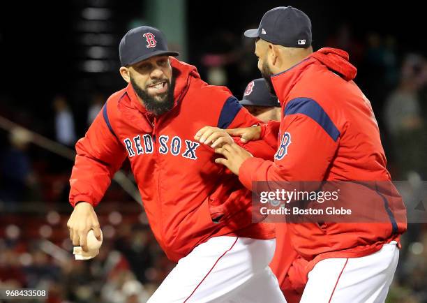 Boston Red Sox player David Price goofs off with teammate Eduardo Rodriguez after he hit him in the back with a rosin bag following the team's 6-0...