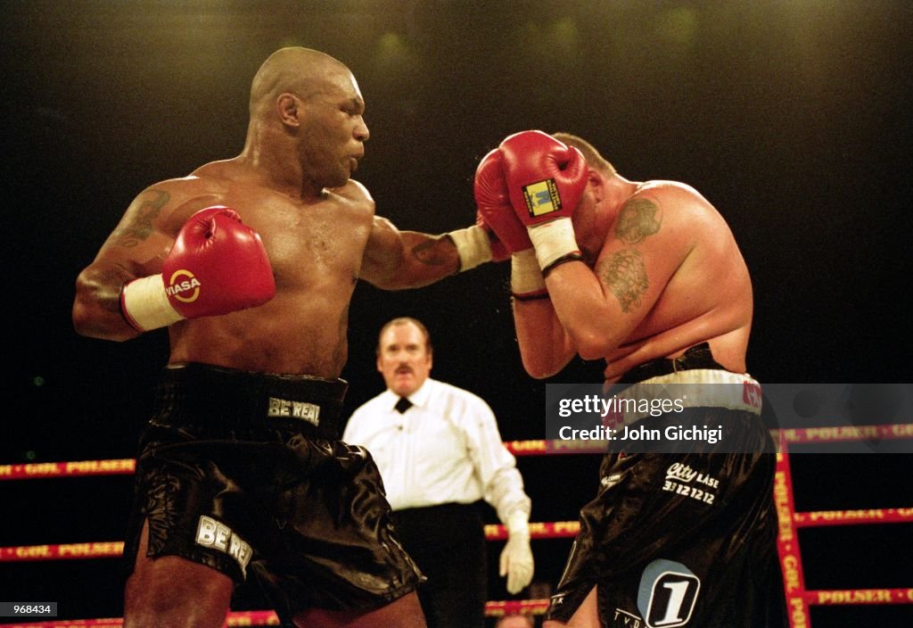 Mike Tyson Of The USA Lands A Punch On Opponent Brian Nielsen Of mike-tyson-of-the-usa-lands-a-punch-on-opponent-brian-nielsen-of
