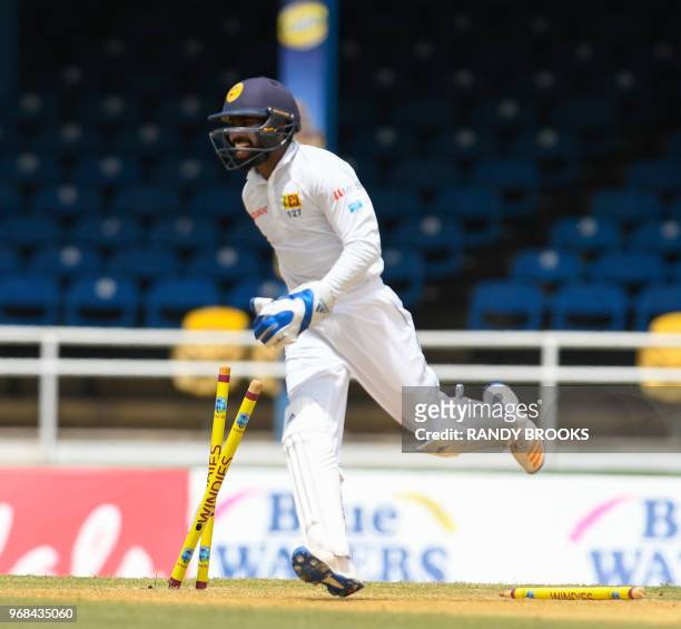 Niroshan Dickwella of Sri Lanka celebrates the dismissal of Devon Smith of West Indies during day 1 of the 1st Test between West Indies and Sri Lanka...