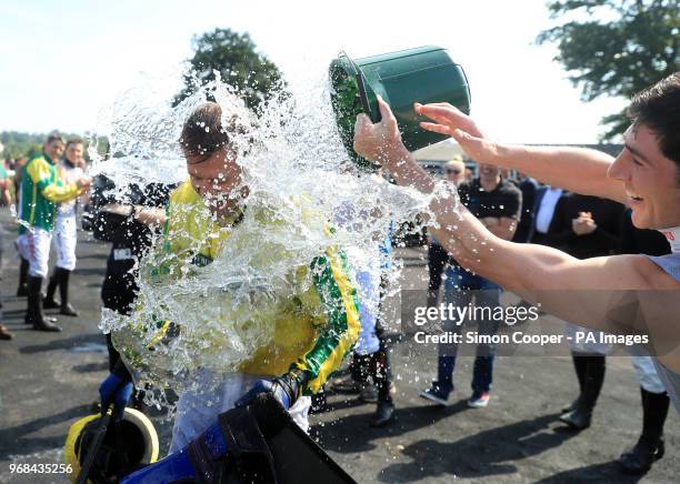 Jockey Andrew Thornton is dowsed in water in the parade ring after his final race as a jockey at Uttoxeter Racecourse.