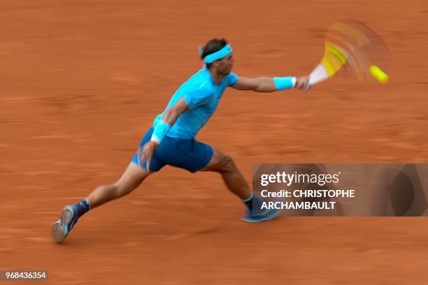 In this photograph taken with a slow shutter speed Spain's Rafael Nadal returns the ball to Argentina's Diego Schwartzman during their men's singles...