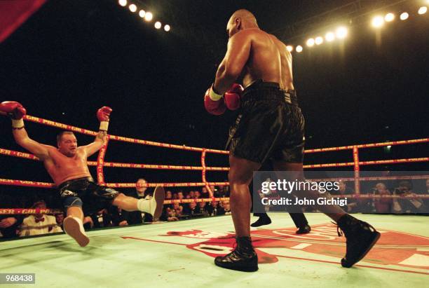 Mike Tyson of the USA knocks down opponent Brian Nielsen of Denmark during the world heavyweight fight at the Parken Stadium in Copenhagen, Denmark....